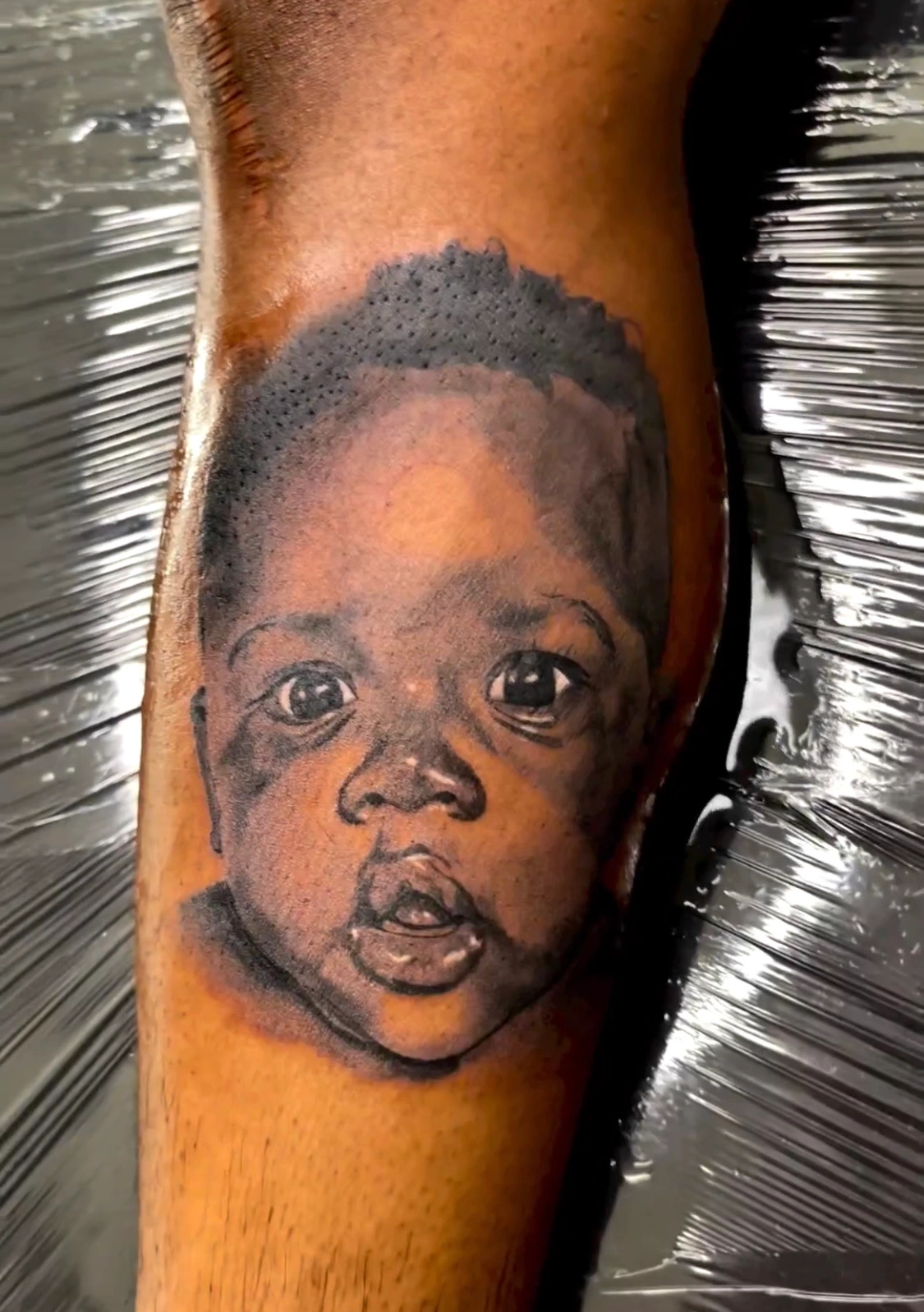 Realistic child portrait tattoo